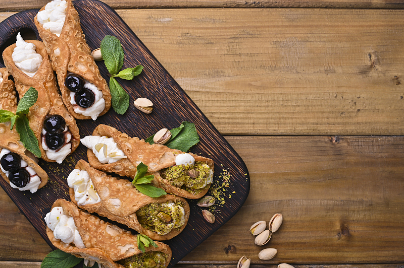 Made with ricotta and fried pastry dough, cannoli comes in various flavors. /CFP