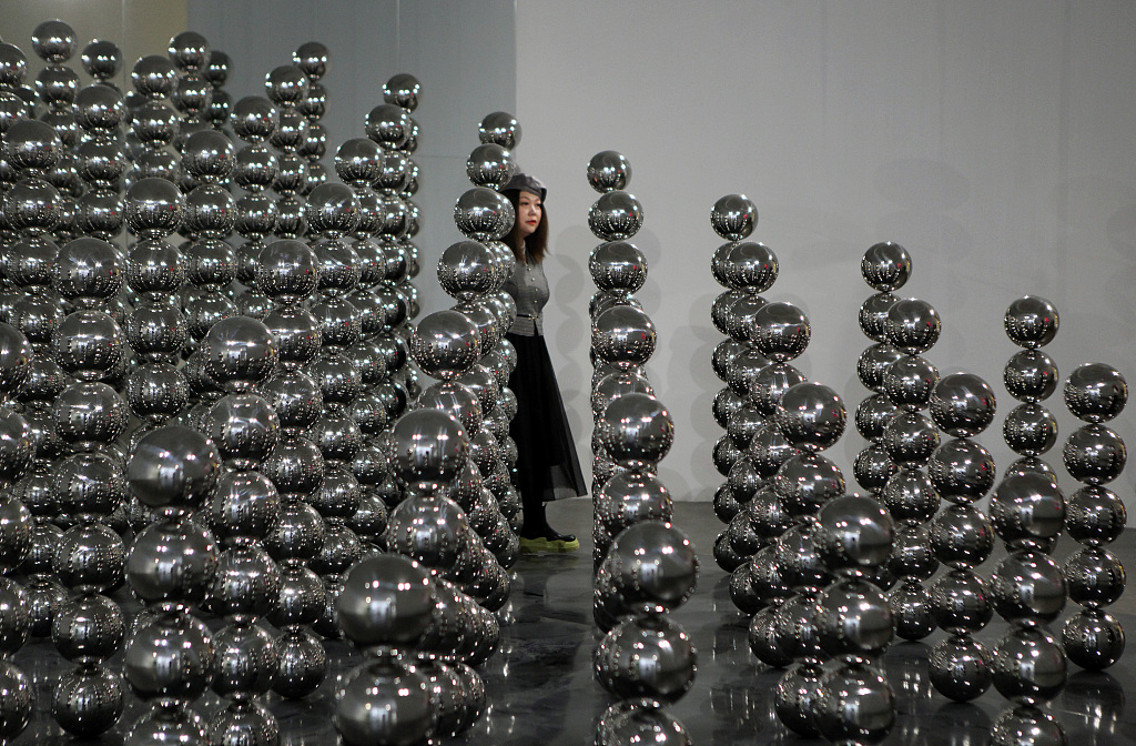 This photo taken on April 28, 2023 shows a visitor interacting with an art installation by French artist Cyril Lancelin at the K11 Art Space in Liaoning Province's Shenyang. /CFP