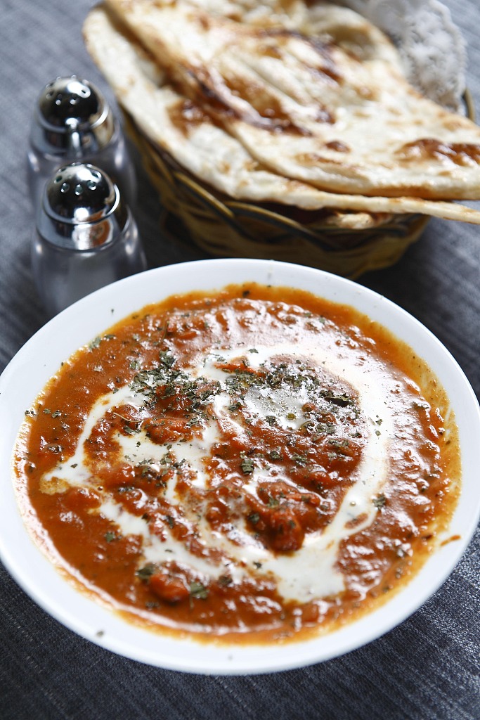An Indian beef curry dish is served with naan bread. /CFP