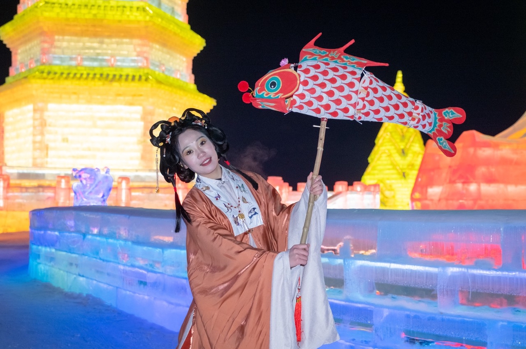 A woman dressed in traditional hanfu attire poses for a photo at Changchun Ice and Snow New World in northeast China's Jilin Province, on January 9, 2024. /IC