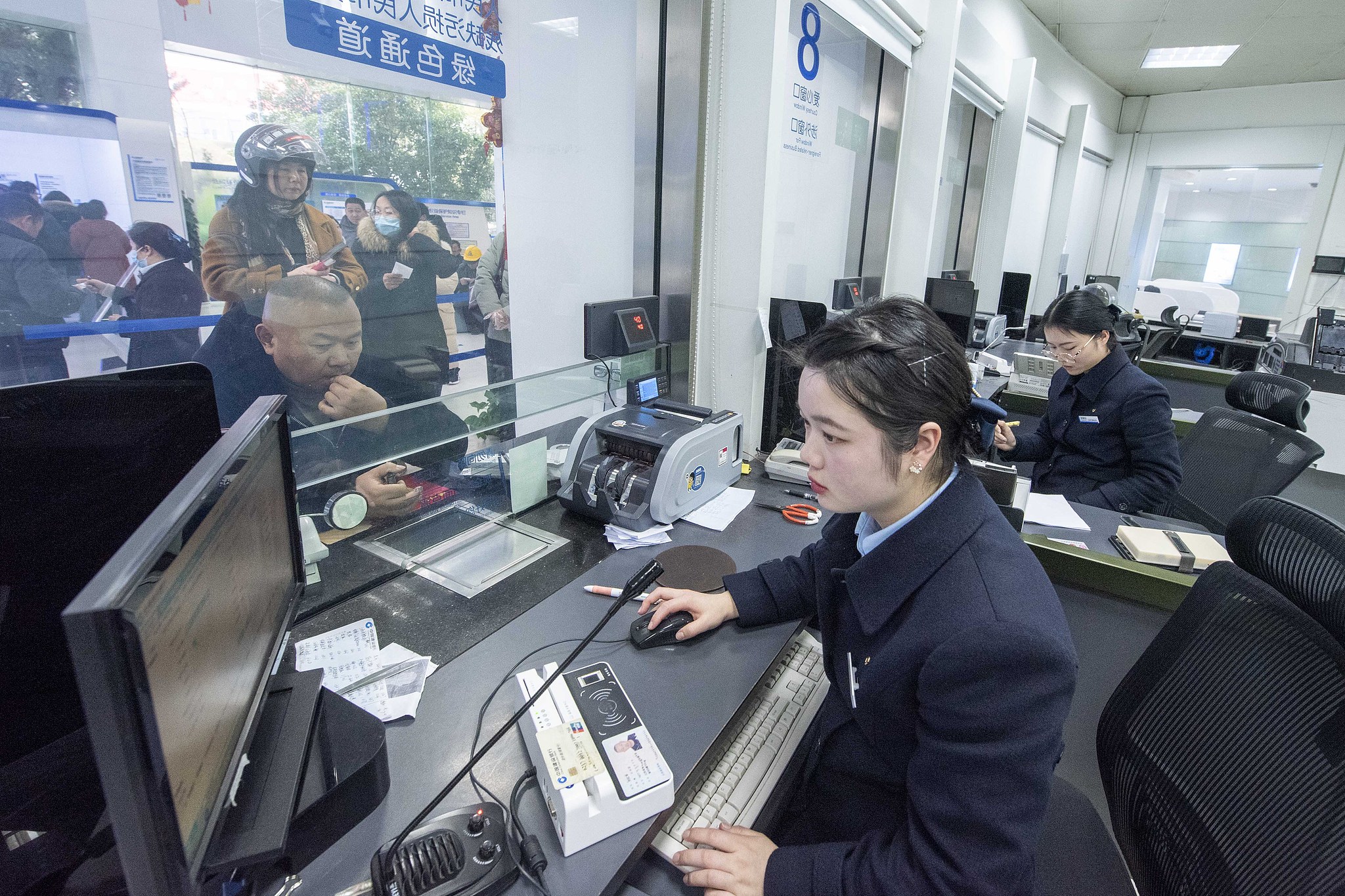 Bank staff conducting transactions at personal banking counters at a bank in Jiangsu Province, China, February 5, 2024. /CFP