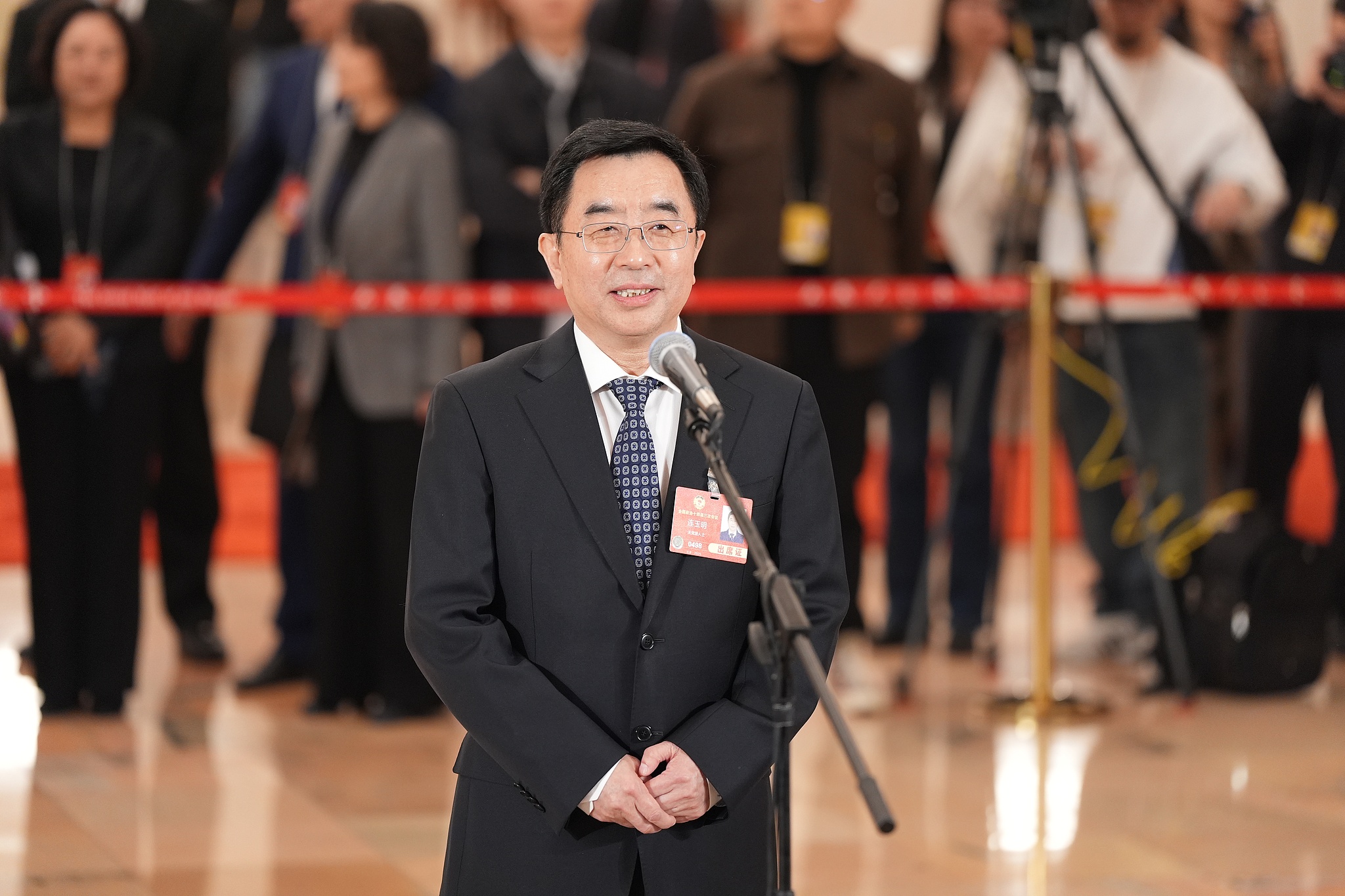 Lian Yuming, chief expert of the Sanjiangyuan National Park Administration, speaks during the Members' Corridor of the third session of the 14th National Committee of the CPPCC in Beijing, China, March 10, 2025. /VCG
