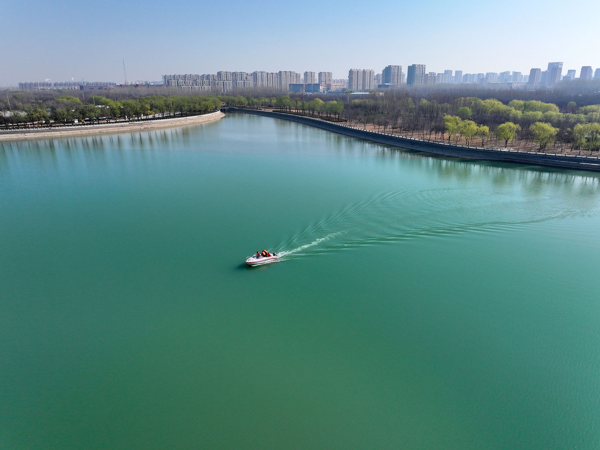 A staff member patrols Jinniu Lake National Wetland Park in Liaocheng City, Shandong Province, east China, March 22, 2025. /VCG