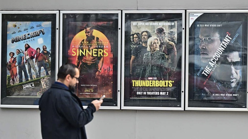 A man walks past movie posters at AMC Theater in Montebello, California on May 5, 2025. /Frederic J. Brown/VCG